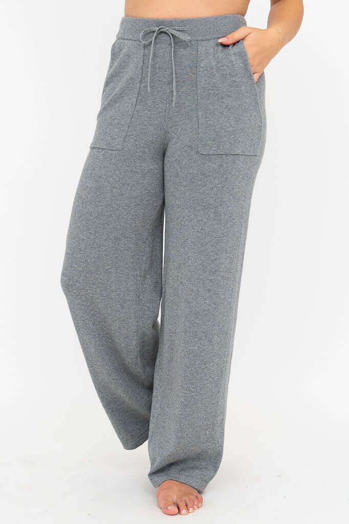 Front view of grey wide leg cotton knit pants with drawstring waist and patch pockets