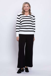 Woman posing in Breton stripe V-neck sweater with ribbed cuffs and hem