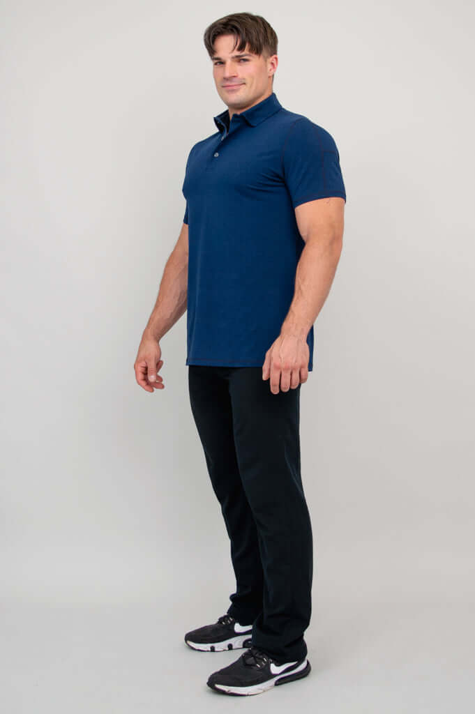 Man in profile wearing navy bamboo polo shirt, hands at sides