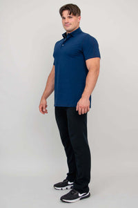 Man in profile wearing navy bamboo polo shirt, hands at sides