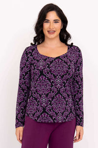 Woman wearing purple damask print sweetheart neckline top with long sleeves