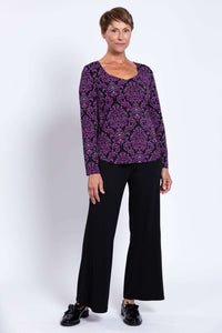 Full body front view of model in purple bamboo top and black wide-leg pants