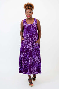 Model wearing a purple floral maxi dress with square neckline and pockets