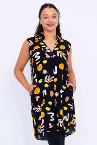 Front view of model wearing Queenie sleeveless tunic with abstract black pattern