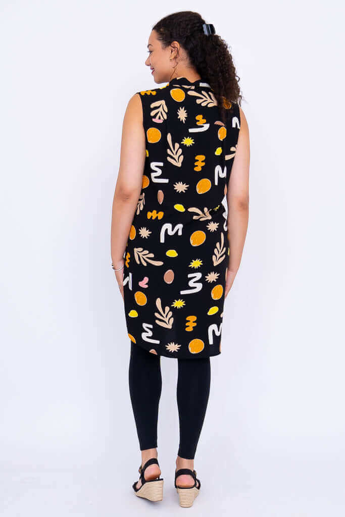 Back view displaying the high-low hemline of the Queenie abstract tunic