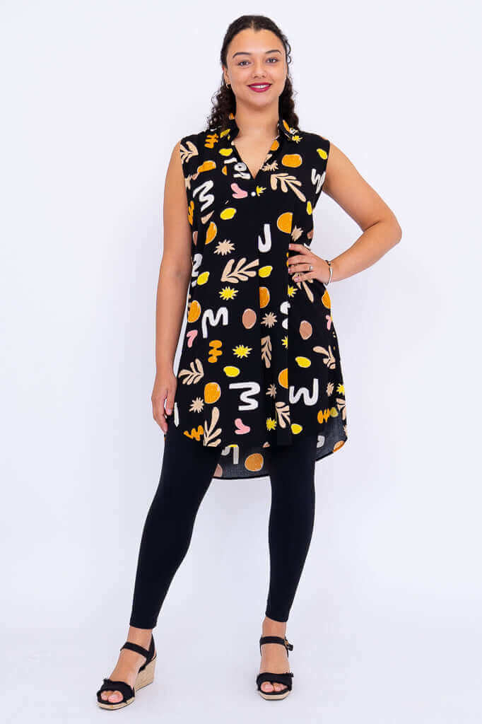 Full body front view of Queenie sleeveless tunic paired with black leggings