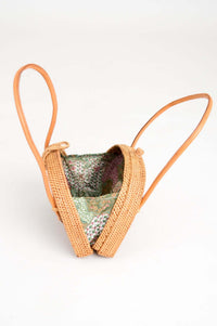 Open rattan bag revealing colorful Javanese Batik fabric lining inside