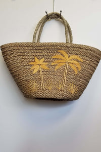 Rattan tote bag with hand-embroidered yellow palm trees and braided handles