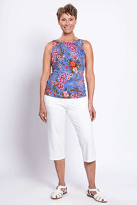 Full body front view of woman wearing high neck side of floral bamboo tank with white pants