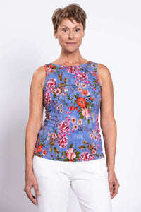 Front view of woman wearing the high neck side of blue floral reversible bamboo tank top