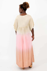 Rear view of a woman wearing a flowy tiered maxi dress with ombre color fade