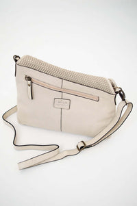 Rear view of ivory woven flap crossbody bag with adjustable strap