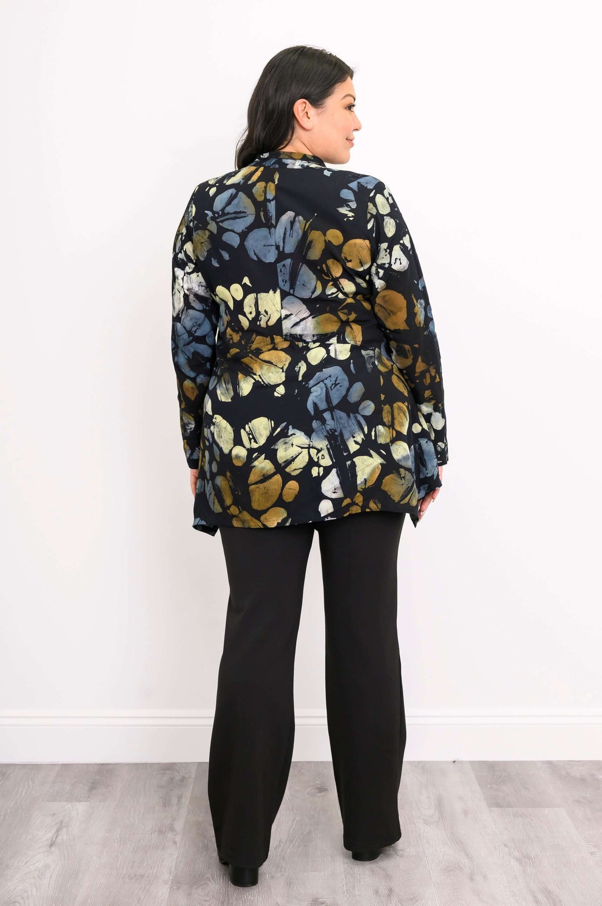 Rear view of model displaying back of Laney Blouse with abstract print