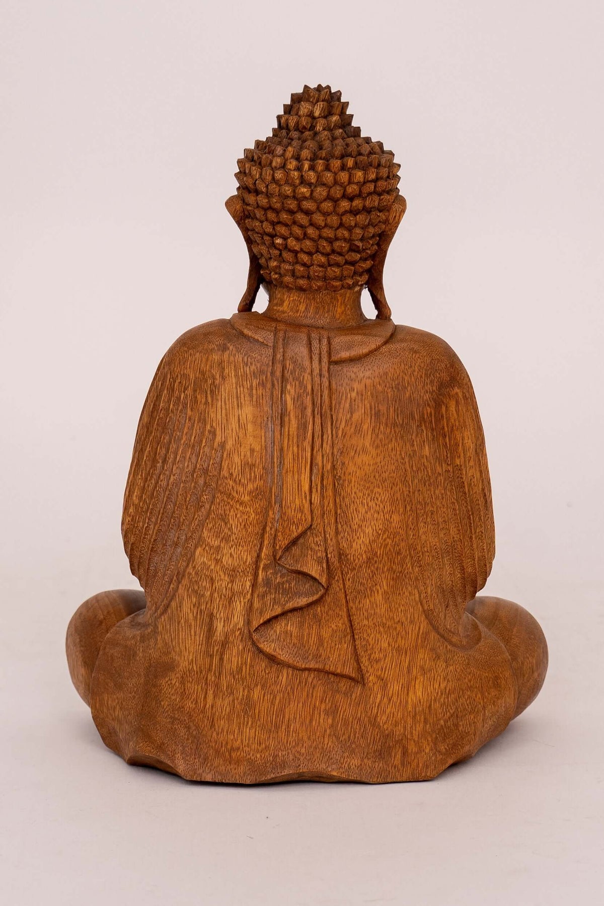 Rear view of a hand-carved Suar wood meditating Buddha statue
