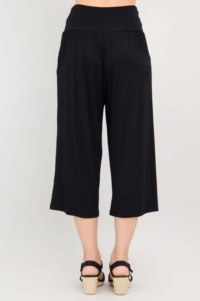 Rear view of black Gaylene capri pants with palazzo leg