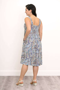 Rear view of woman in blue paisley midi dress with shirred back