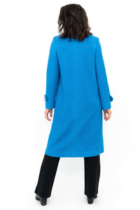 Back view of a woman wearing a long blue wool coat