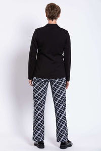 Rear view of woman wearing a black tailored blazer and black and white checked pants