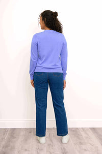 Rear view of woman in light purple cardigan and blue jeans