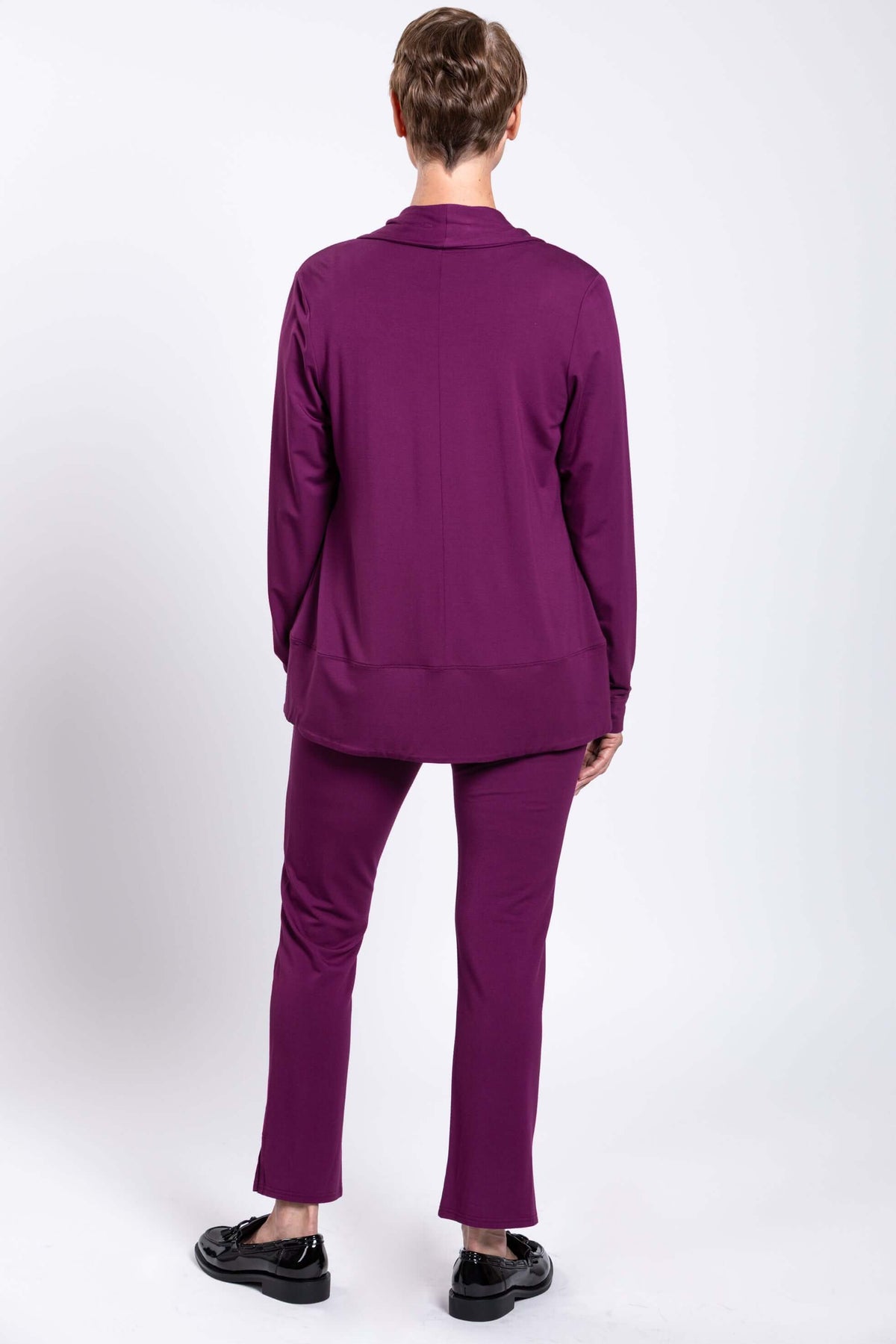 Rear view of woman wearing plum purple shawl collar jacket and matching pants