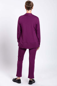 Rear view of woman wearing plum purple shawl collar jacket and matching pants