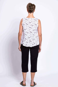 Rear view of woman wearing white floral sleeveless peplum tank