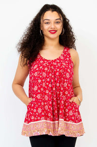 Woman wearing a red floral pleated tank top with pockets, front view