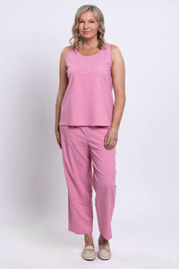 Woman standing in pink tank top and pants, relaxed fit, full length front view