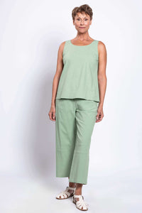 Woman modeling sleeveless green linen top and cropped boardwalk pants, relaxed front pose