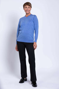 Woman modeling blue Merino V-neck sweater with relaxed posture
