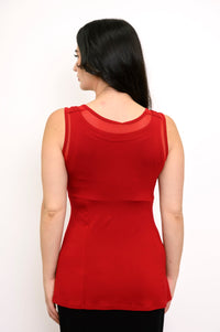 Back view of woman wearing red tank top with mesh detail and slim fit