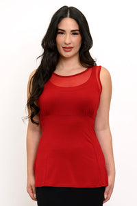 Front view of woman wearing a red sleeveless top with mesh detail and black pants
