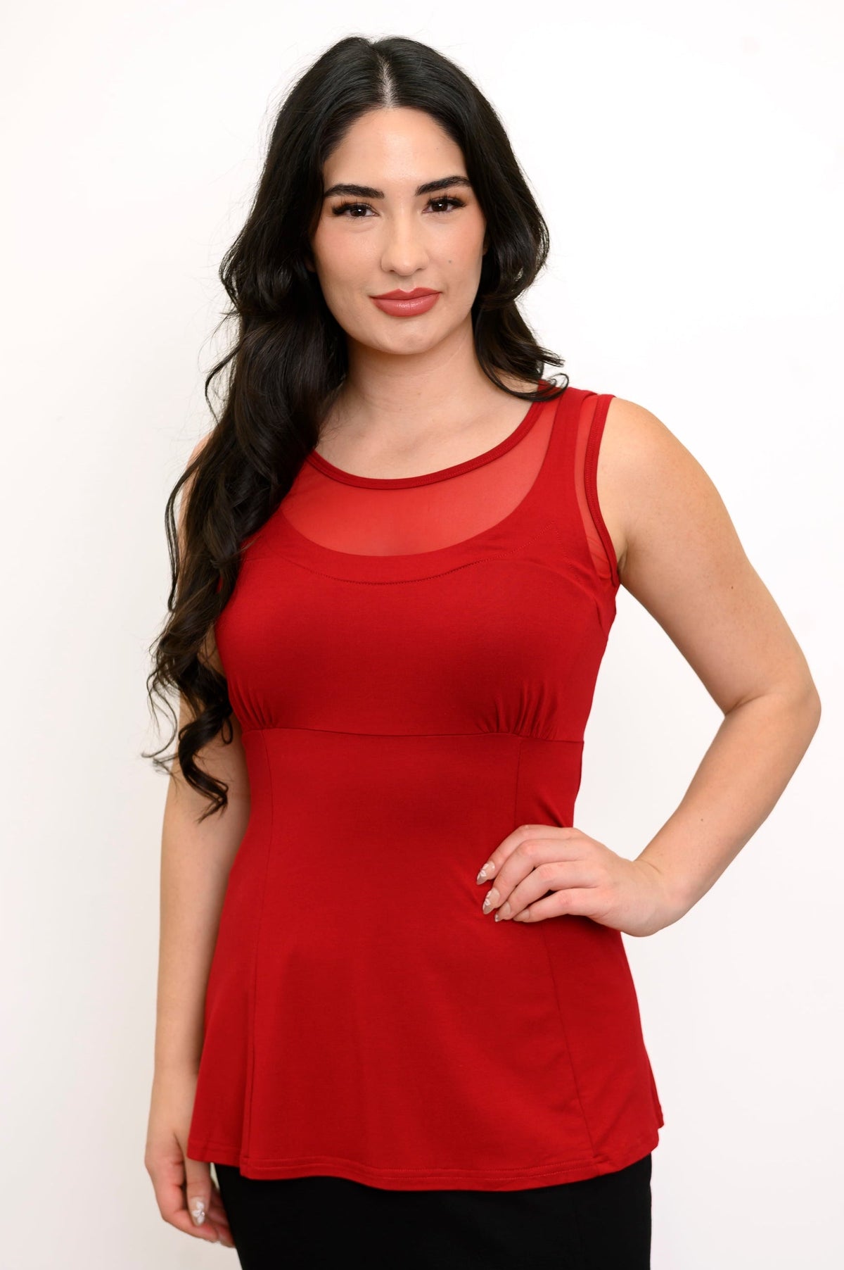 Close up from view of woman modelling a red sleeveless top with mesh panel and ruching in the bust
