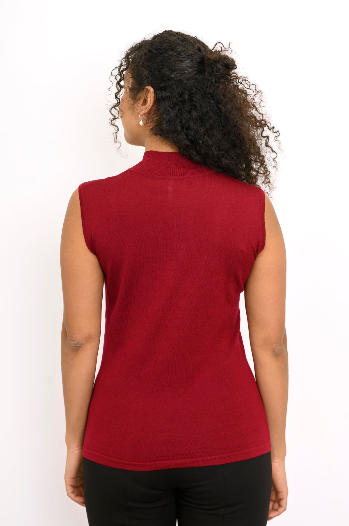 Rear view of a sleeveless dark red knit top showing smooth back fit and clean shoulder tailoring.