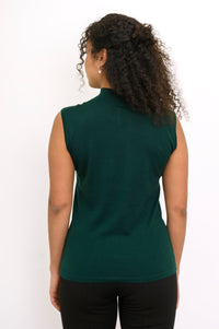 Back view of a woman wearing a hip length deep forest green sleeveless merino wool top in studio.