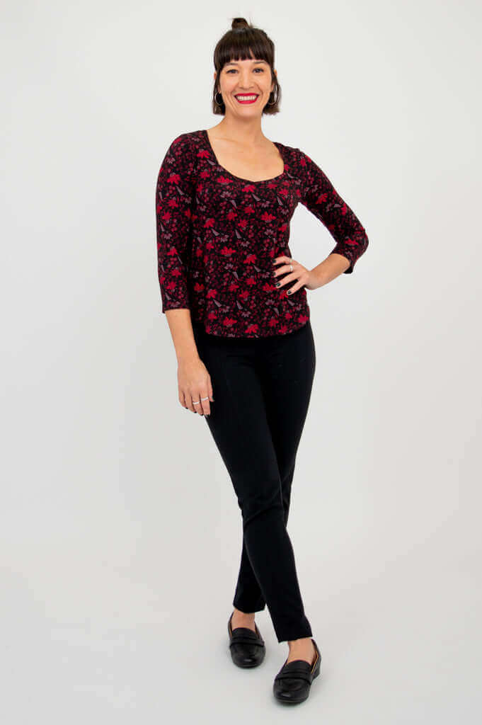 Model posing in Ritzy Top Lotus Black, hand on hip, full outfit in view