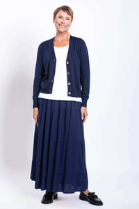 Smiling model in navy tiered maxi skirt and navy cardigan, front view