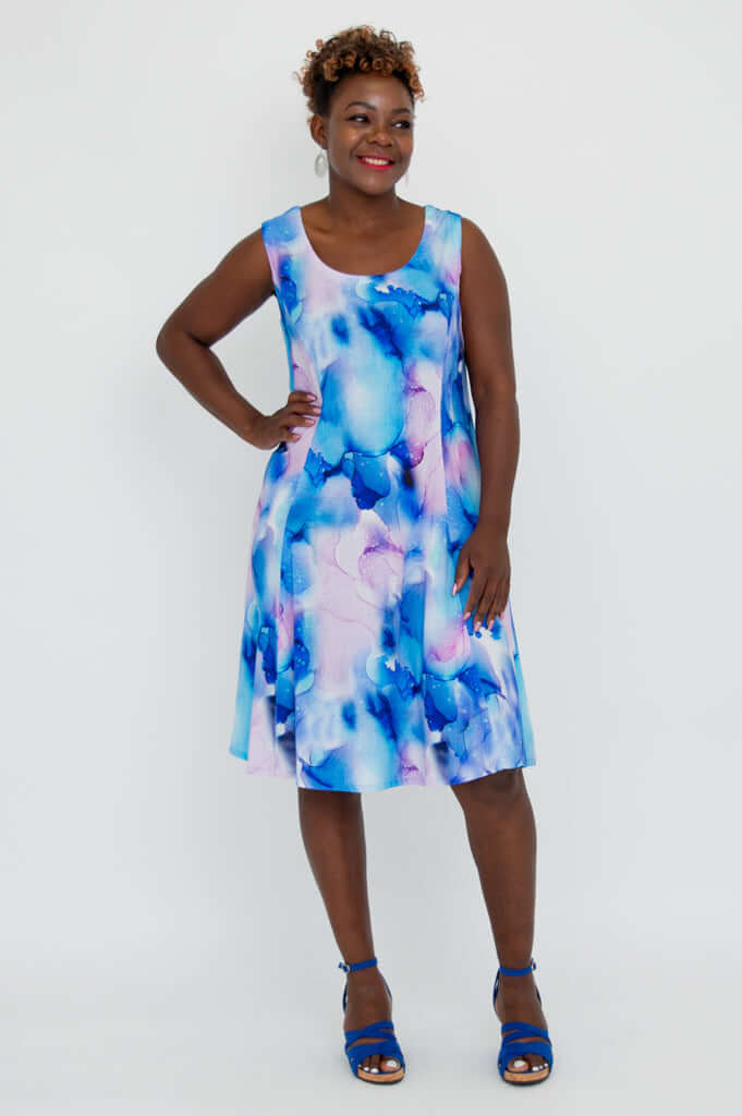 Model smiles in sleeveless blue watercolor Sara dress