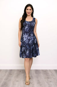 Full body shot of Woman smiling in blue floral dress facing the camera