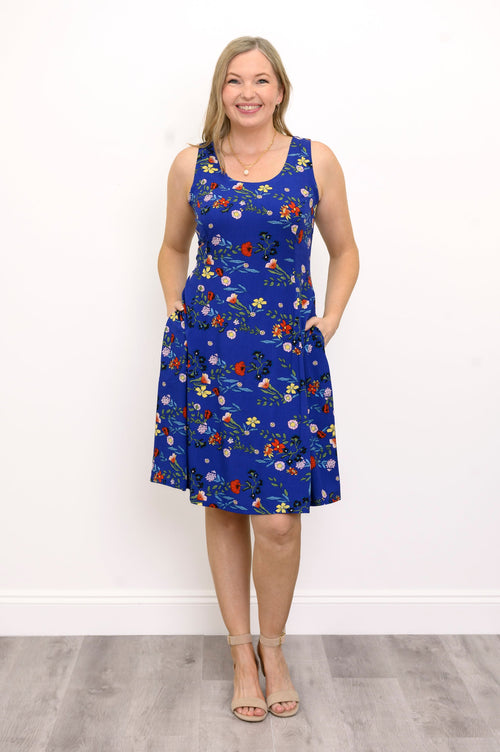 Front view of woman wearing a blue and red floral dress against a white background