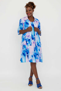 Model pairs blue watercolor Sara dress with coordinating button-up shirt
