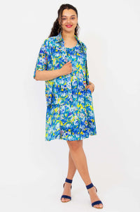 Sara dress blue floral with matching blouse, model holding lapel