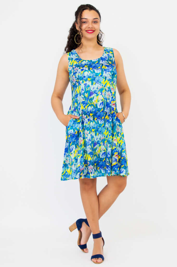 Model showing pockets in Sara blue floral dress, hands at hips