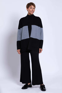 Woman smiling in Seltic Sweater, front angled view highlighting colour block design