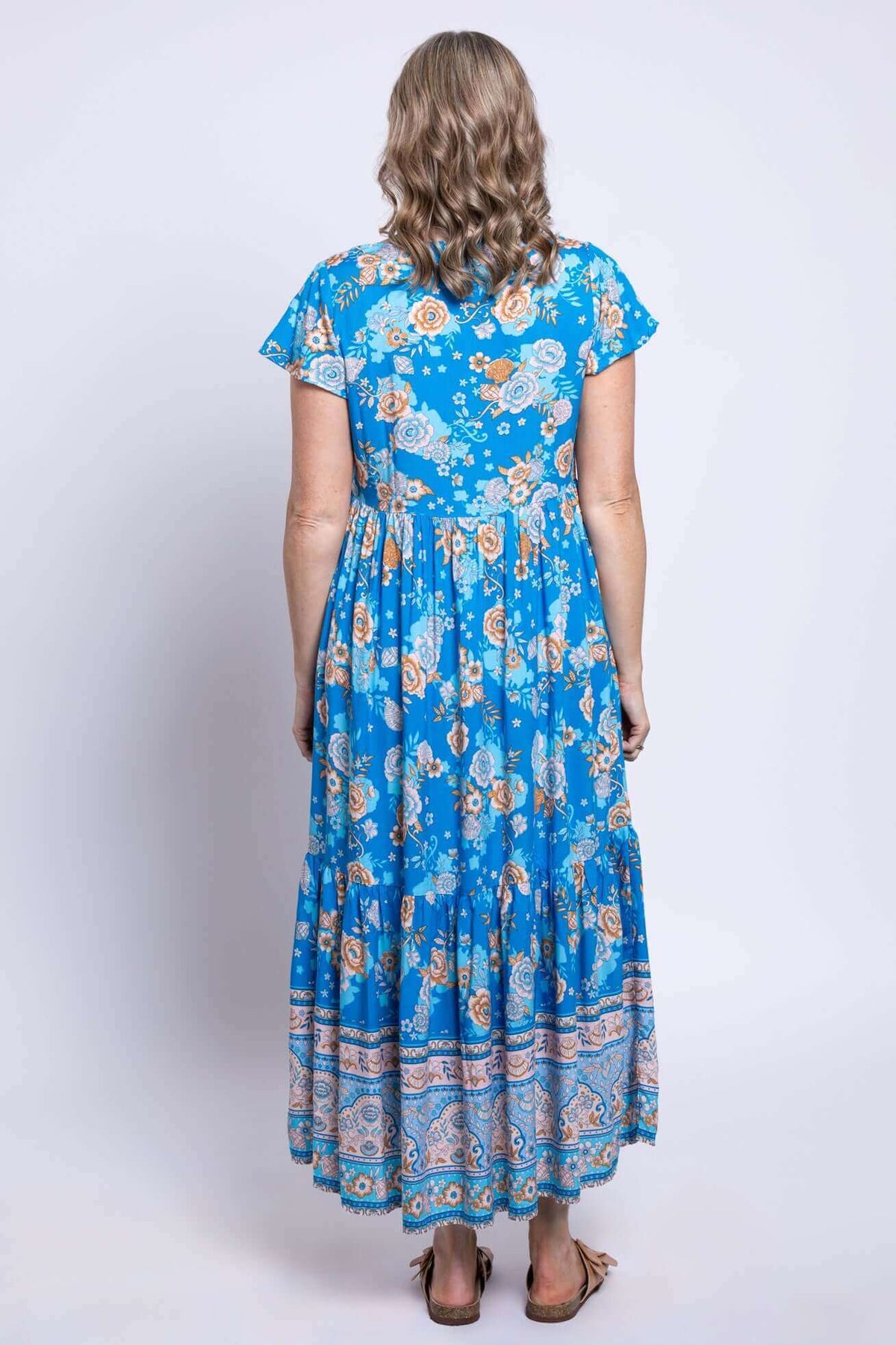 Back view of woman showing patterned fabric and tiered design of Sharpie Dress