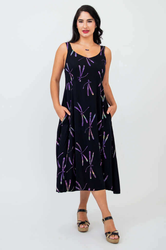 Front view of woman wearing black sleeveless dress with purple dragonfly pattern