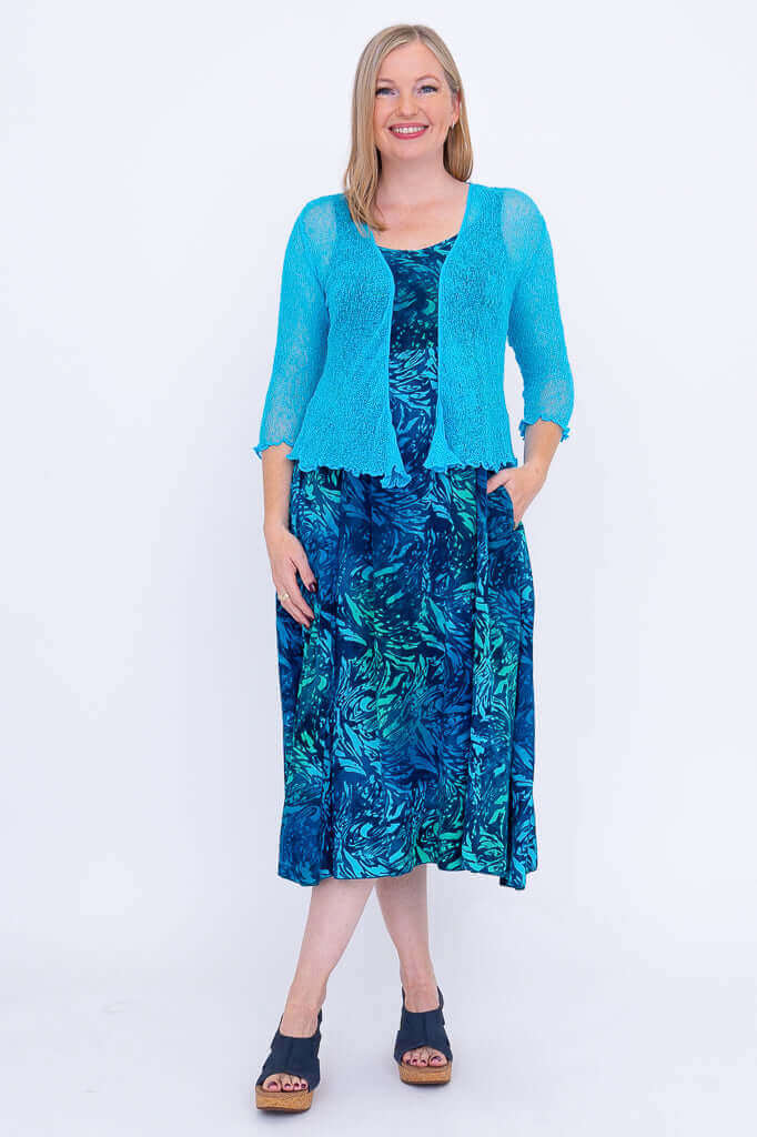 Model wearing Shauna dress in Lagoon print with a light blue shrug