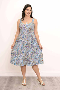 Woman holding out the skirt of a blue paisley A-line dress, displaying the flowy fabric