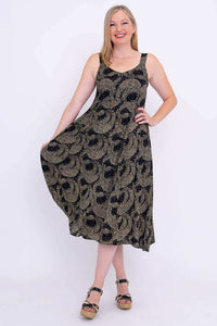 Woman holding out skirt of black and gold Shauna dress, showing A-line silhouette