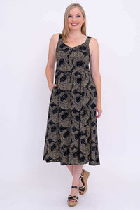 Full front view of woman in Shauna empire waist dress, hands in pockets